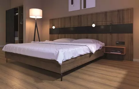 臥室空間展示木質床架與EGGER深色超耐磨木地板，搭配暖色調燈光與落地燈。